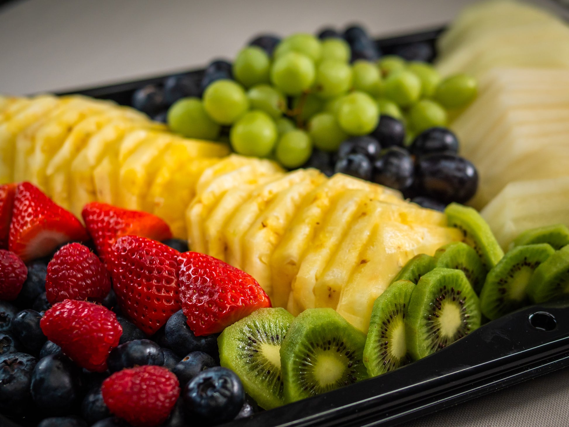 Sub Side’s Fresh Fruit Medley (serves 12/24) features neatly arranged sliced pineapple, kiwi, carved melon, strawberries, fresh seasonal berries, and mixed grapes.