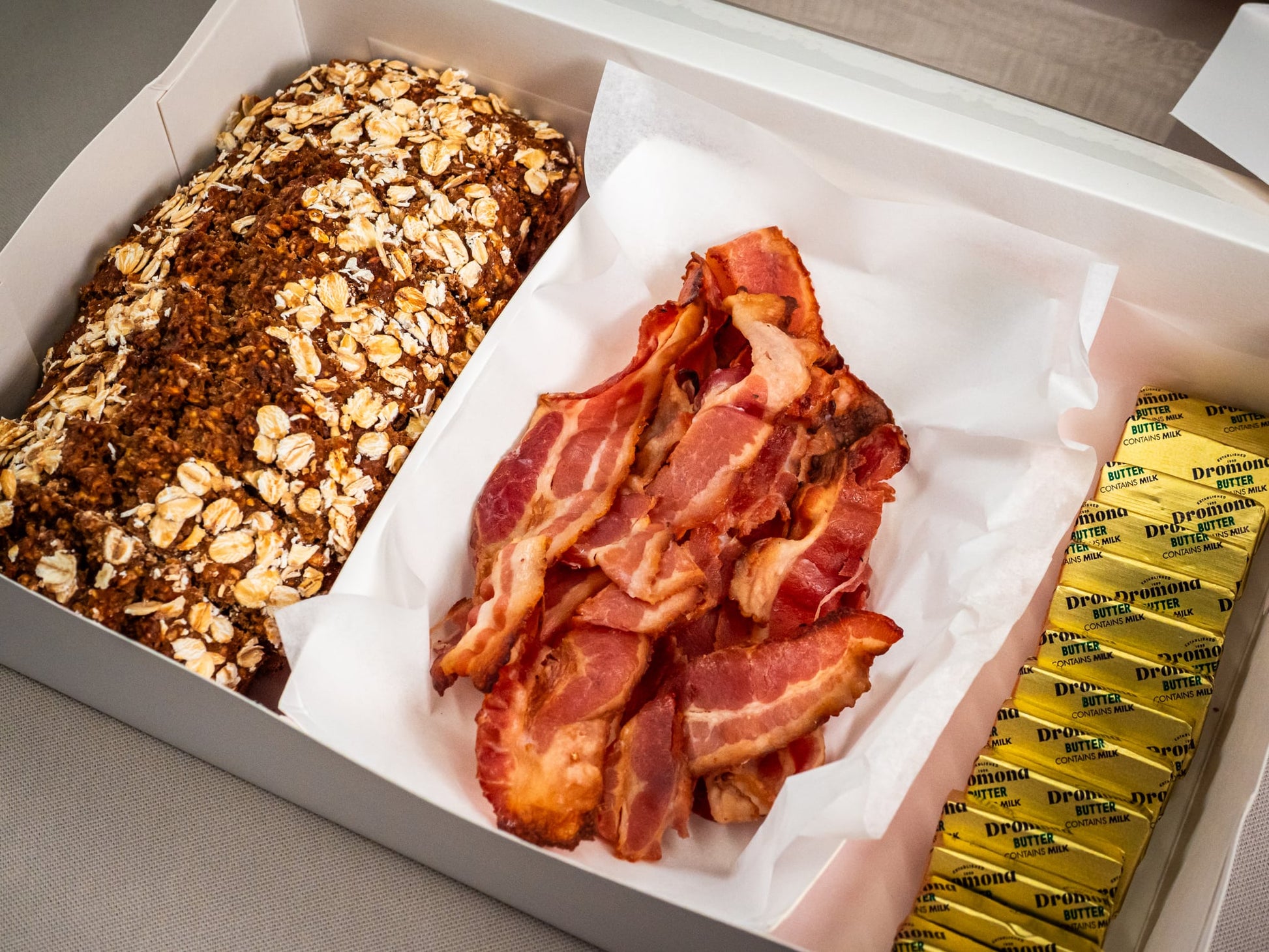 Sub Side Homemade Treacle Wheaten & Crispy Bacon (serves 5 pax): includes oat-topped brown bread, crispy bacon strips, and several portions of creamy butter.