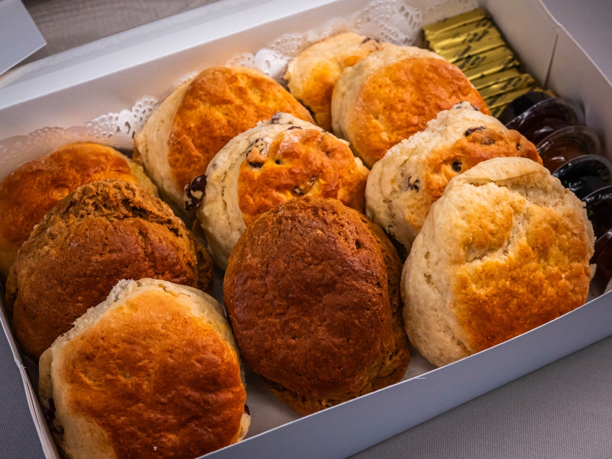 Sub Side’s Freshly Baked Scones (10 pieces) box features plain and raisin scones, served with packets of butter and fruit jam.