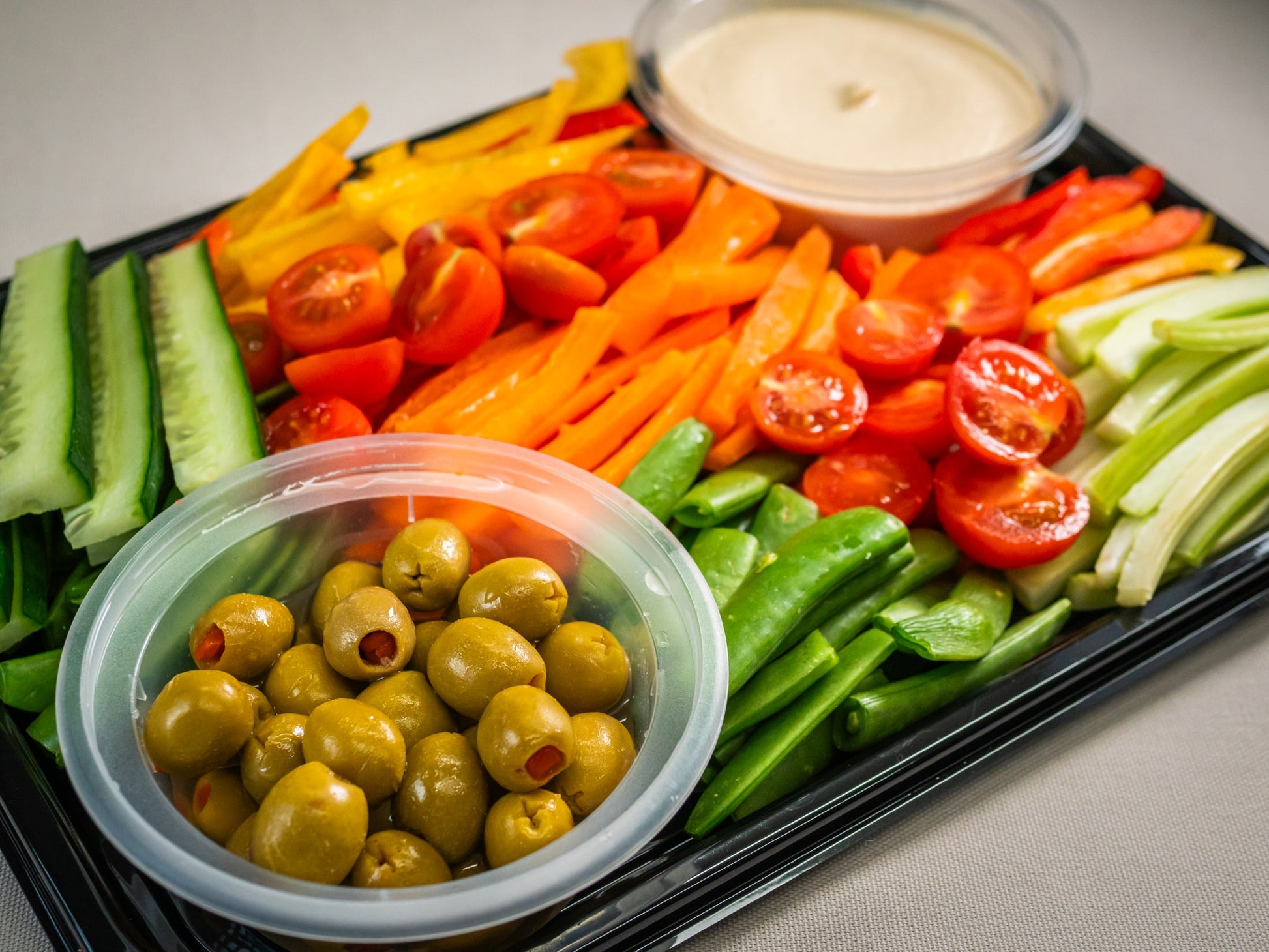 The Sub Side Garden Fresh Veggie Platter (serves 8) includes assorted fresh vegetables, marinated olives, and two containers of creamy hummus for dipping.